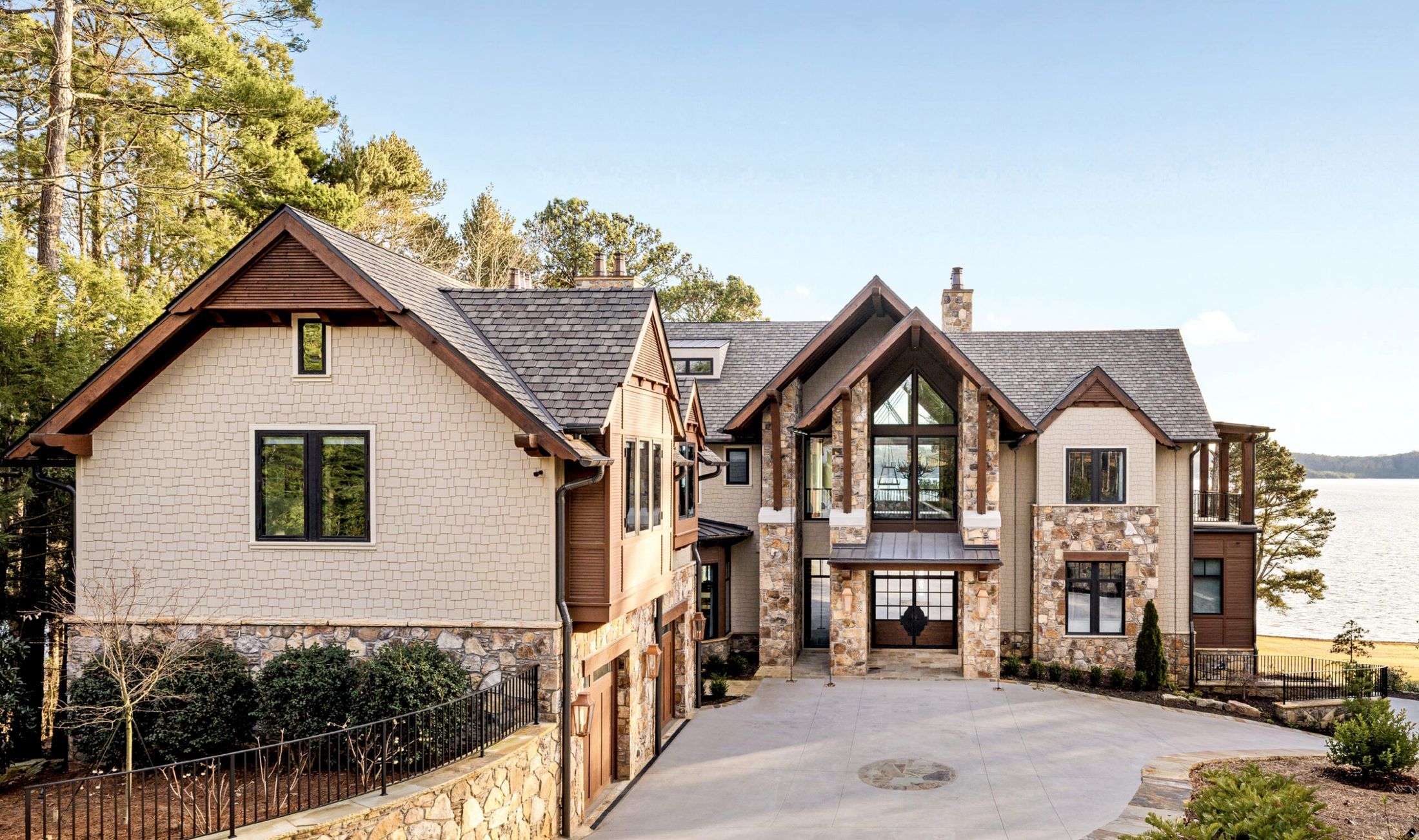 A lakefront estate in stone, cedar shake and heavy timber, with the water beyond